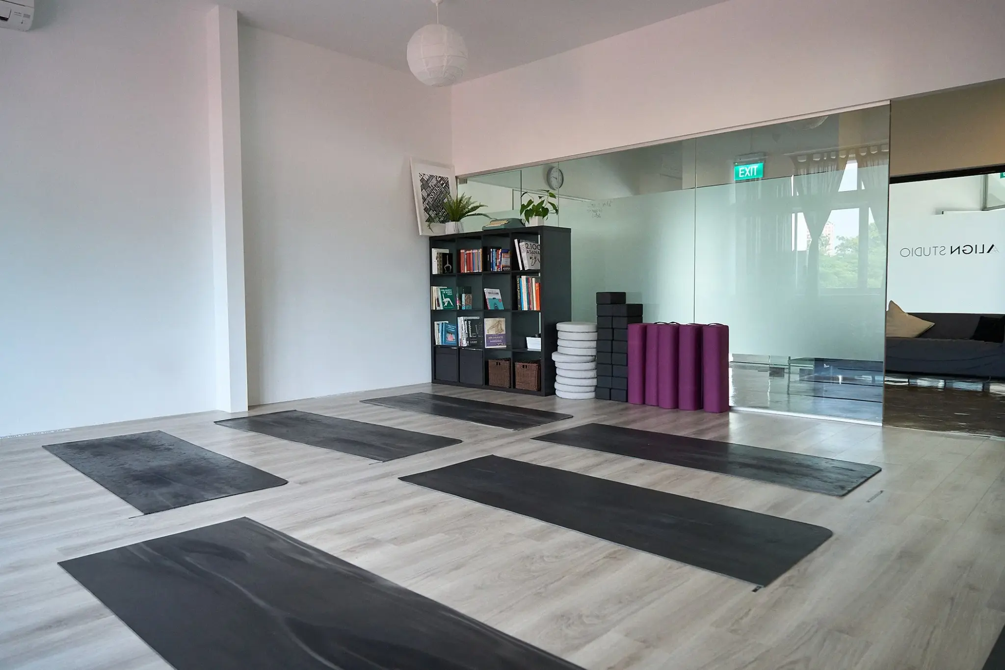 The practice room with mats laid out in front of a mirrored wall